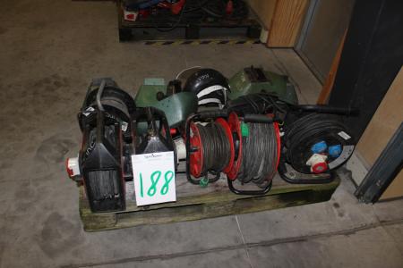 Palle with cable rolls and welding helmets.