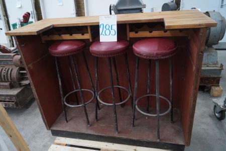 A bar with 3 bar stools