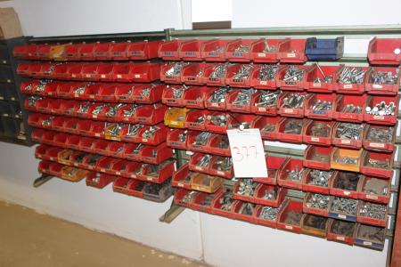 Various nuts and bolts in red assortment boxes.