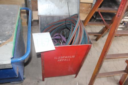 Box with oily and gas hoses and welding hoses.