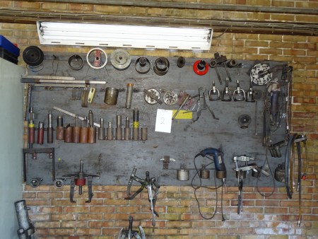 Toolboard with contents: pullers and various power tools