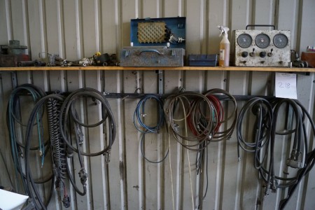 Various snakes along the wall. + tool on rack