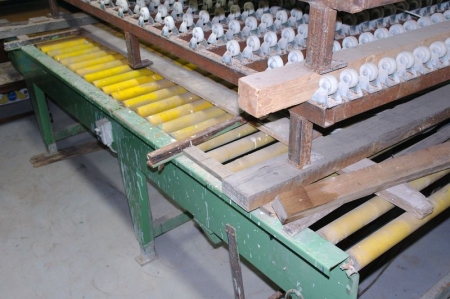 Special driven roller conveyor. Rolls have friction stop feature