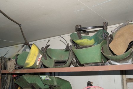 Shelf with welding helmets.