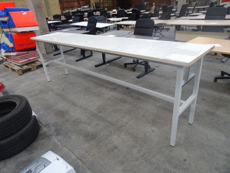 White laminate table, plain wear. 304x61x94cm.