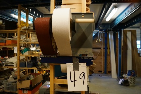 2 rolls of abrasive paper on stand.