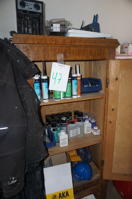 Cabinet with contents of various consumer goods + vacuum cleaner.