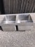 Stainless steel countertops with 2 sinks. Wall mounted. Length: 274cm, and width: 61cm.