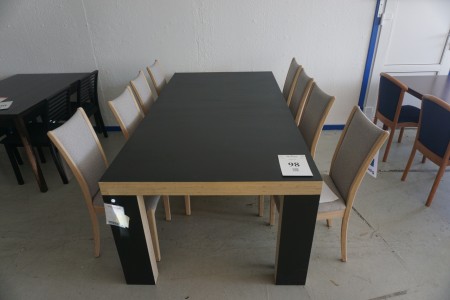 Langbord. 220x110x77 cm. Sort linoleum. Benene er vendbare. Med 8 stole.