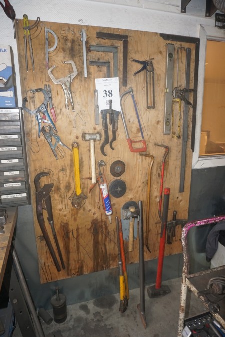 Tool board with content, pullers, angular pipe wrenches and more.