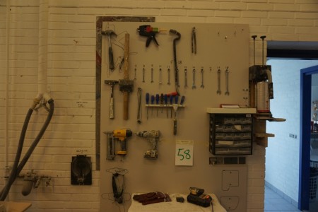 Tool board with various tools and power tools.
