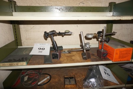 Various measuring watches on tripod + measuring tools.