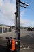 Electric stacker. Hour meter shows 2961, max lift height 415 cm, with stand plate and hanger. With undercarriage lift works periodically. Charges included. Machine tested and running
