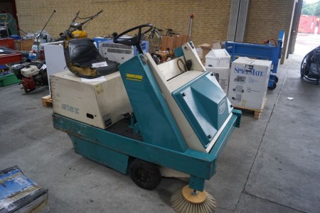 Industrial vacuum cleaner on wheels brand TENNANT model 215E. The machine seems batteries have collapsed and need to be replaced.