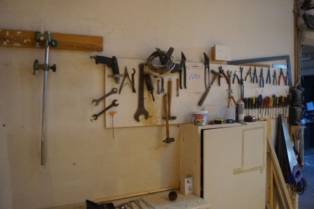 Blackboard with various hand tools and 10 fox tails.