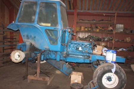 Ford tractor, TW 20, separated. Has been used for tractor pulling. Part laying in the room for the tractor is included.