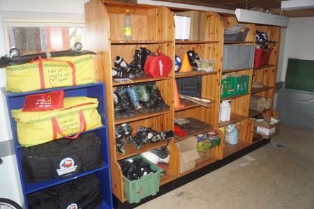 Lot of toys in shelving, including roller skates, skates, soccer, cones and more.