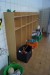 Dressing rack with content, including badminton rackets, balls, bricks and more.
