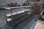 Steel table with shelves, l: 244cm, b: 76cm, h: 89cm.