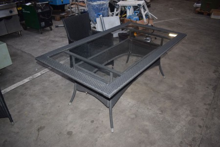 Table with glass top, l: 180cm, b: 100 + 8 chairs.