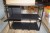 Brand new metal shelf in black with dividing room. Dimensions: 70cm x 30cm x 57cm. Plus 1 chair in the rattan.