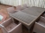 Havemøbler. Stort bord med træ-bordplade, kant af brun rattan kunstflet. 6 stole af brun rattan kunstflet (et par stole er slidt i sædet)