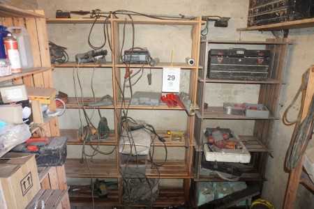 Various power tools, lamps, etc. on shelves.