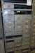 Rack with assortment boxes containing various screws, washers, couplings, etc.