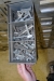 Rack with assortment boxes containing, among other things drills (20 mm to 45 mm), screws, bolts, nuts.