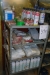 Rack with various consumables. gloves + cut + paste cans with release agent, etc. + 3 section steel shelving.