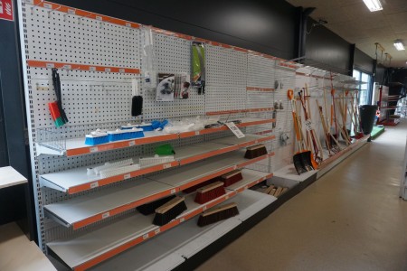 Exhibition shelf with perforated plates and shelves on the wall