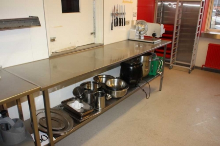 Table of stainless steel with content div. bowls, jugs, heating boiler.