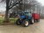Traktor, Marke: New Holland, Modell TM135 Mit Quicke Frontlader Modell: 985.