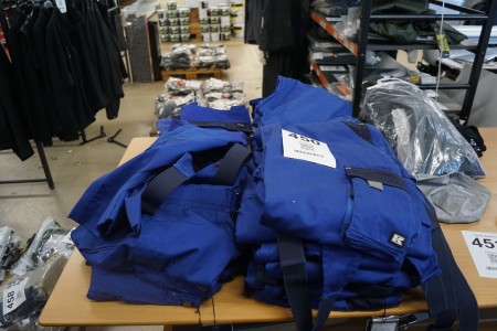 Large batch of work trousers on table, Brand: Kramp.