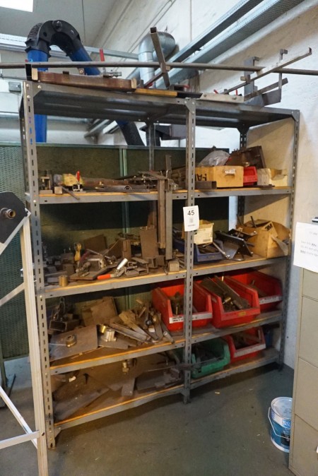 Steel shelf containing various irons.