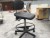 Raising / lowering table with office chair + cabinet on wheels
