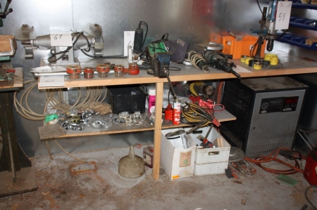 Workbench with vice threading cutter + content below table (except the charger) + assortment boxes on the wall.