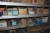 3 section steel shelving + 4 section range rack containing: screws, bolts, nuts, etc.