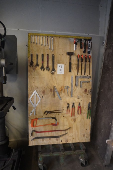 Various hand tools on work board.