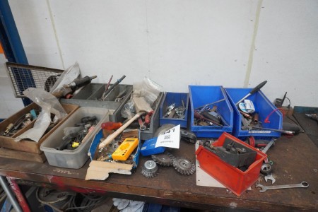 Contents of mixed tools on top of workshop table