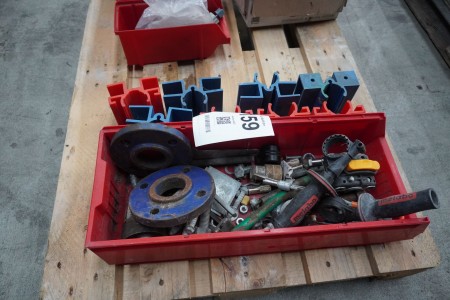 Pallet with various spare parts for power tools, bricks for scaffolding, etc.