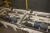 Motorized chain conveyor for pallets. 2 rocker sections. Total length approx. 9 meters. Truck protection. + Grille guard and 4 noise / welding sections, Troax. Sick safety sensors