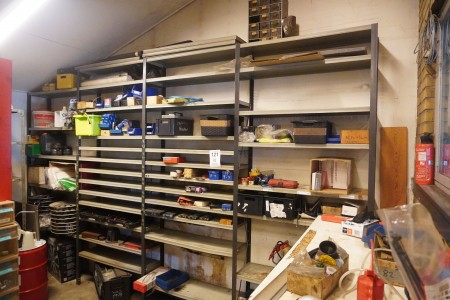 Workshop shelf containing various special tools, hubcaps, screws, bolts etc.