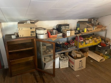 2 shelves of contents with various spare parts