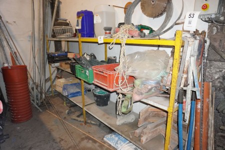 Contents on shelf of chainsaw, wall ties, straps, etc.