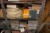 Bookcase containing various gloves, prototypes, laboratory equipment, etc.