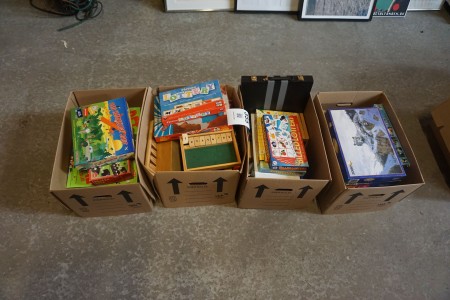4 boxes with various board games and puzzles